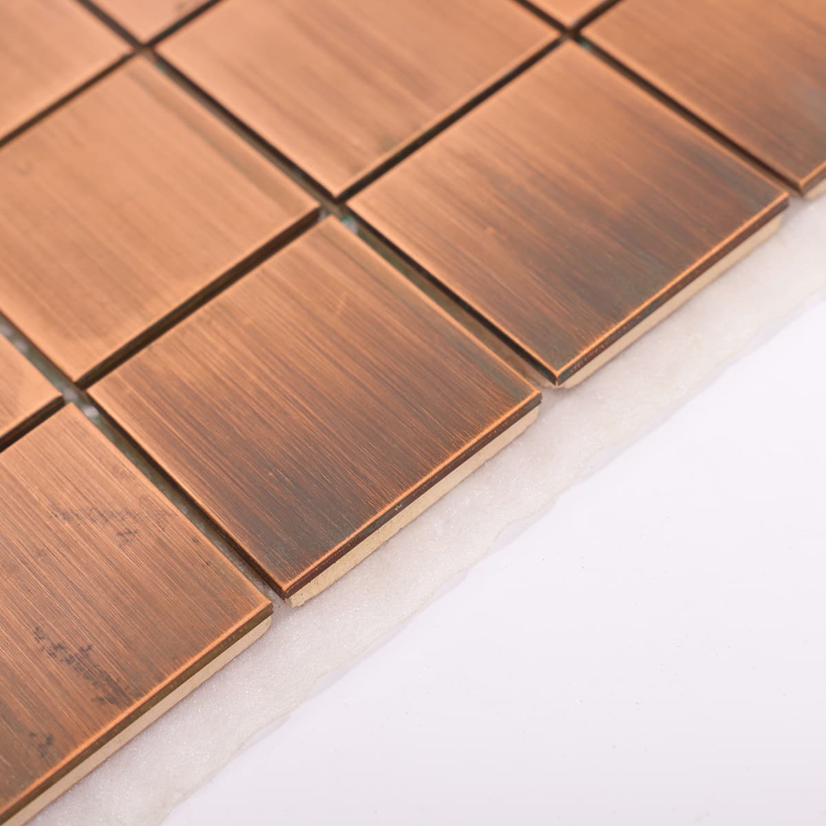 Side detail of copper square mosaic tile layout