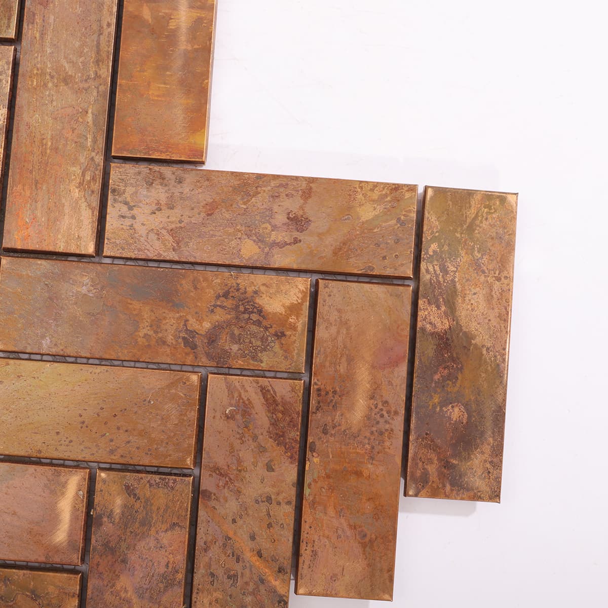 Corner close-up of copper mosaic tile with patina texture
