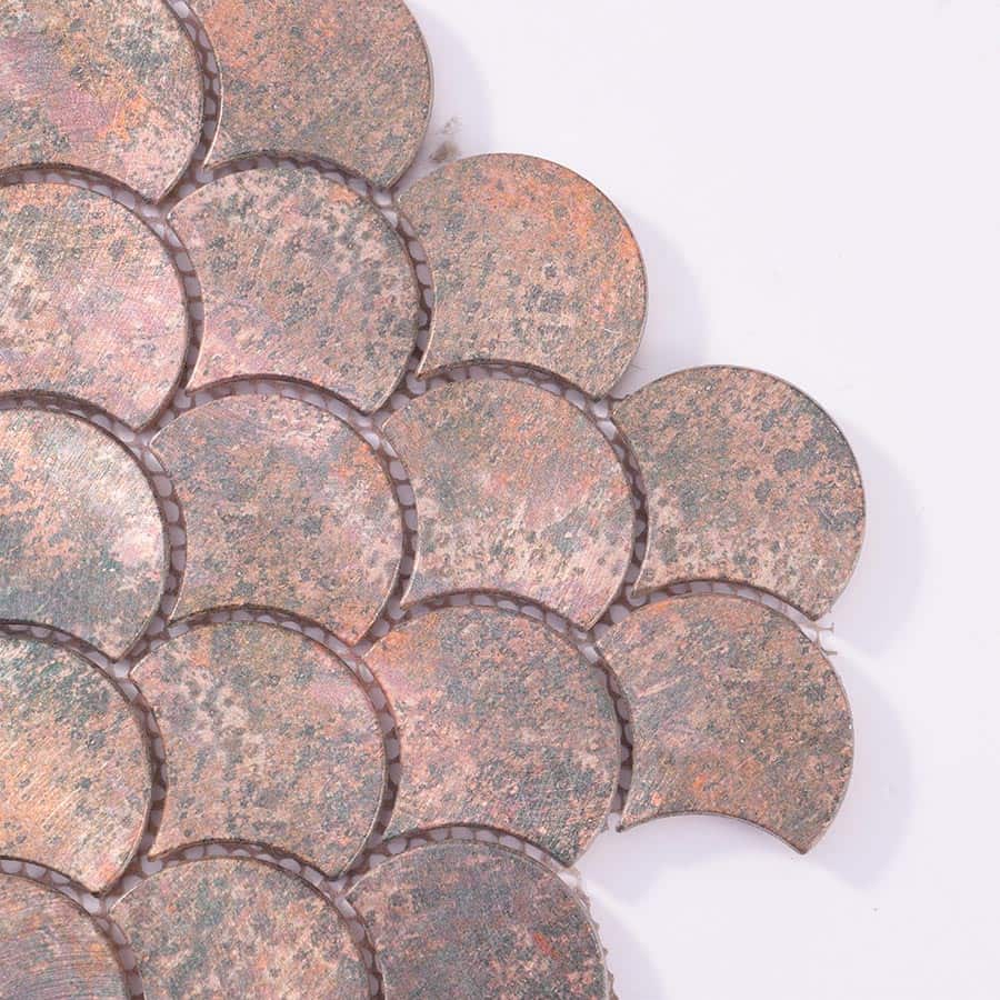 Corner closeup of copper tone fish scale aluminum mosaic tiles