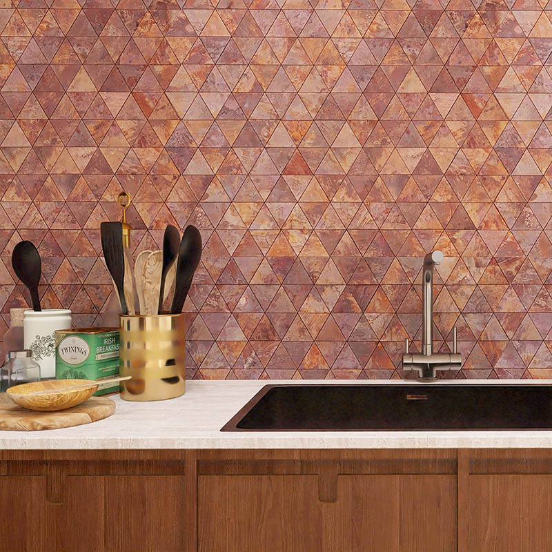 Copper triangle mosaic tiles backsplash behind kitchen sink with warm patina texture