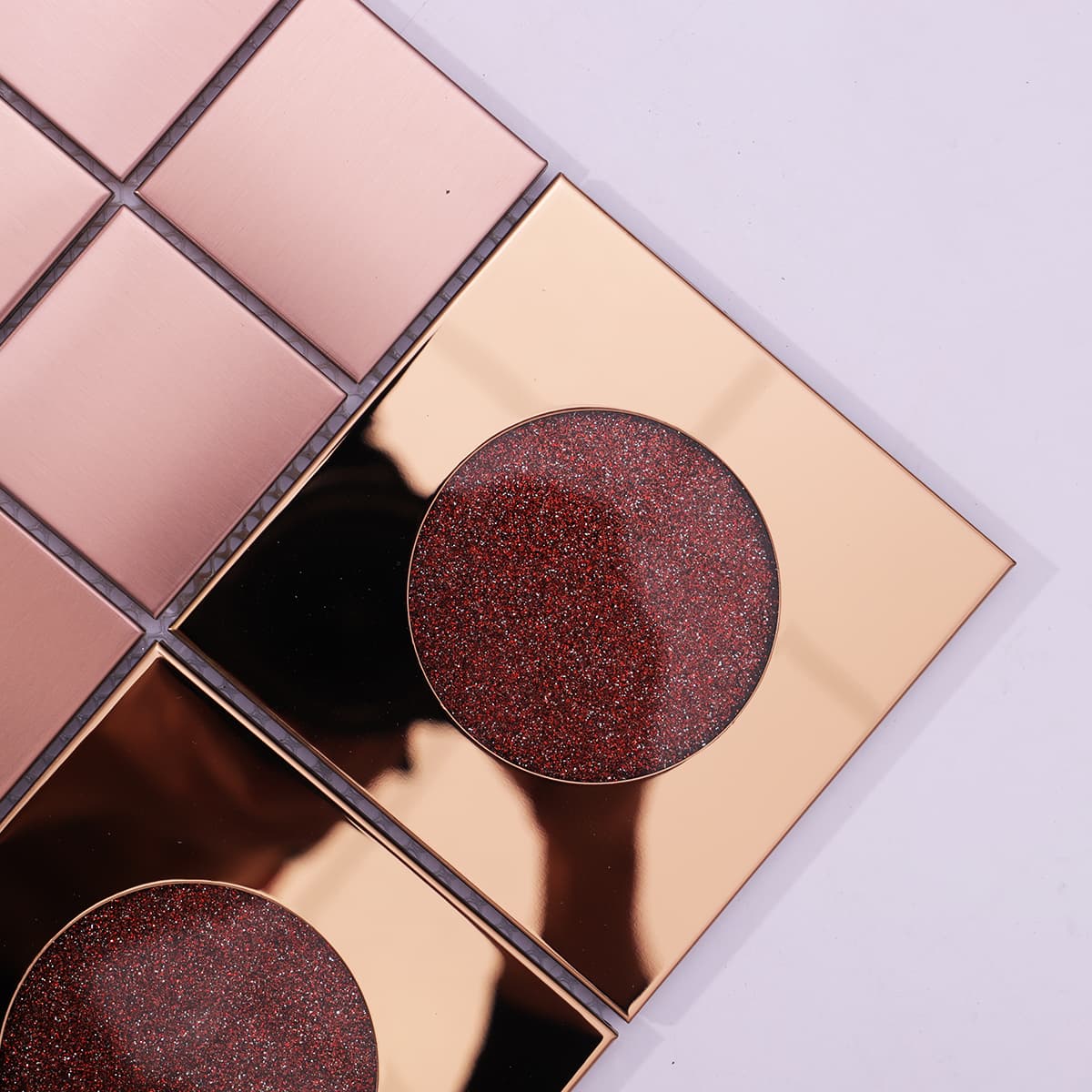 Corner close-up of rose gold and red glitter circle mosaic