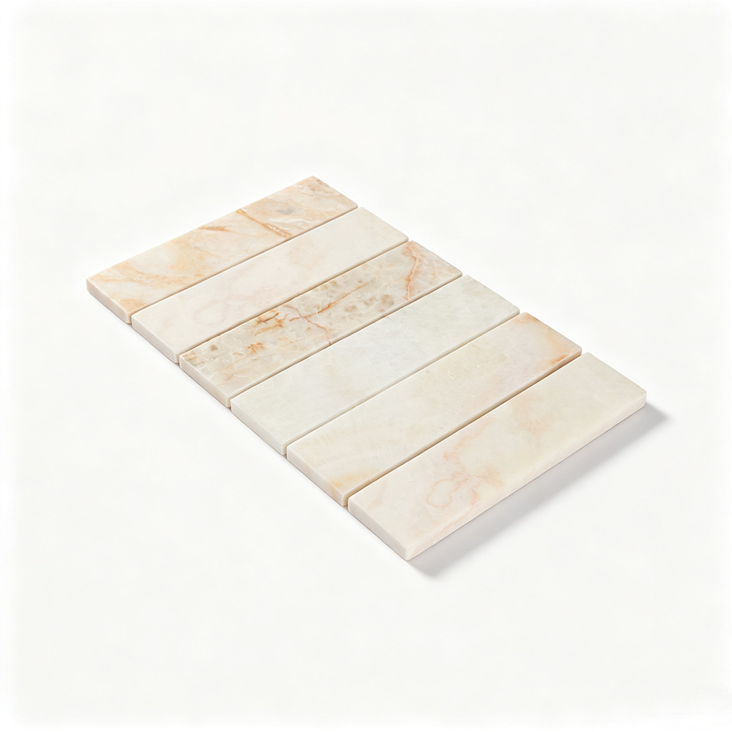 Angled view of a cream linear marble mosaic sheet with warm natural veining