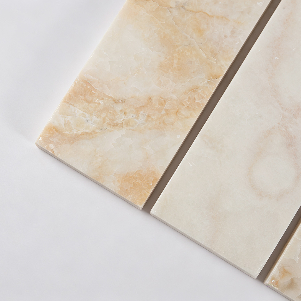 Close-up of cream marble strips with translucent crystals and warm veining
