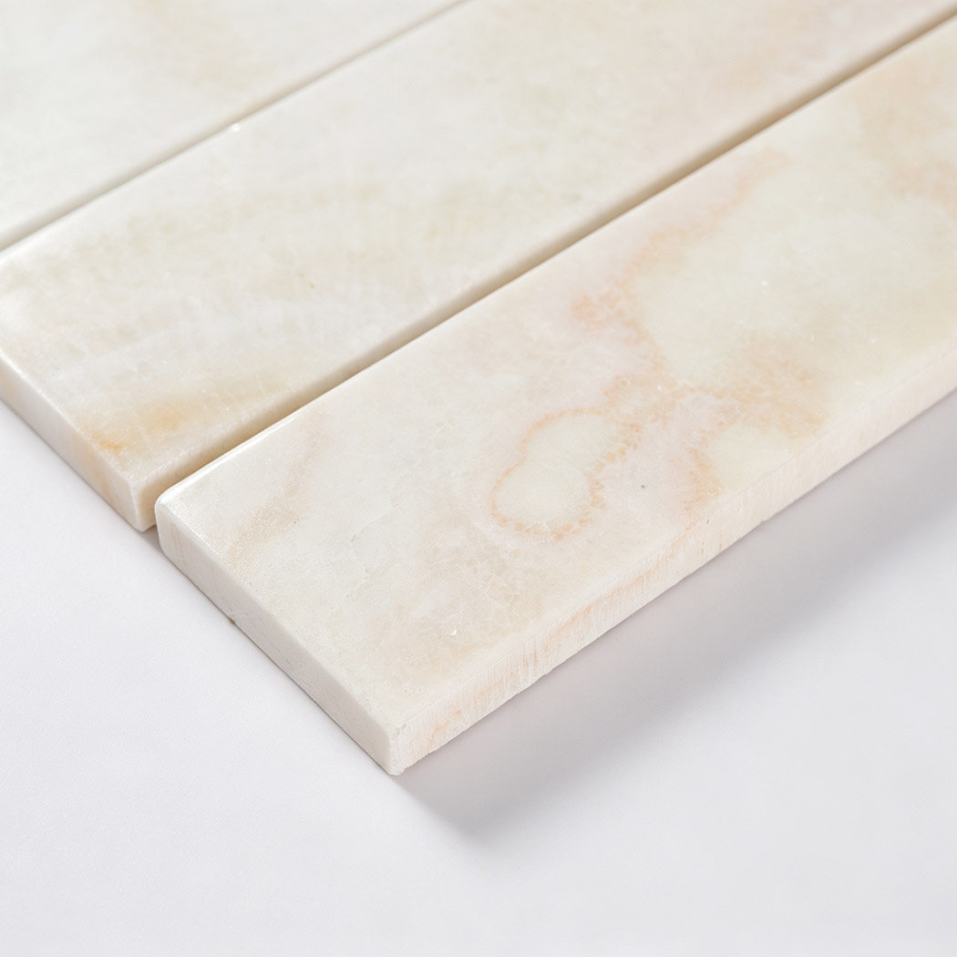 Angled close-up showing the smooth surface and thickness of cream marble strips
