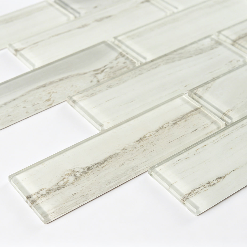 Cream white glass subway tile close up with translucent surface and gray veining