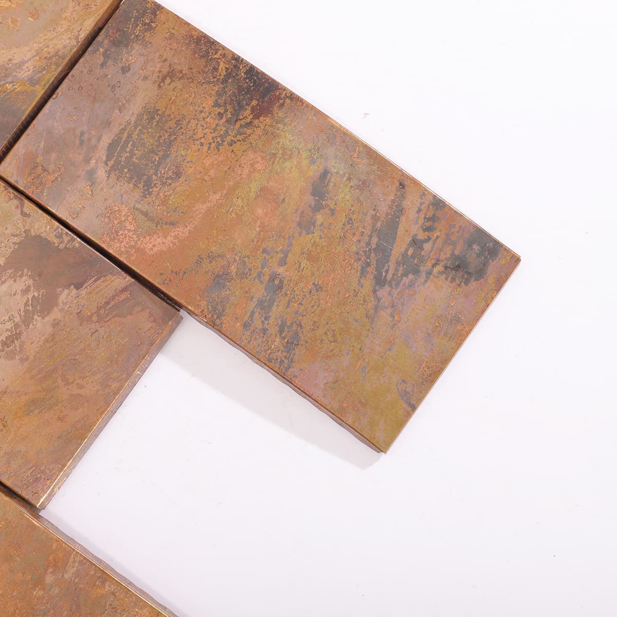 Close-up of curved copper mosaic tile corner detail