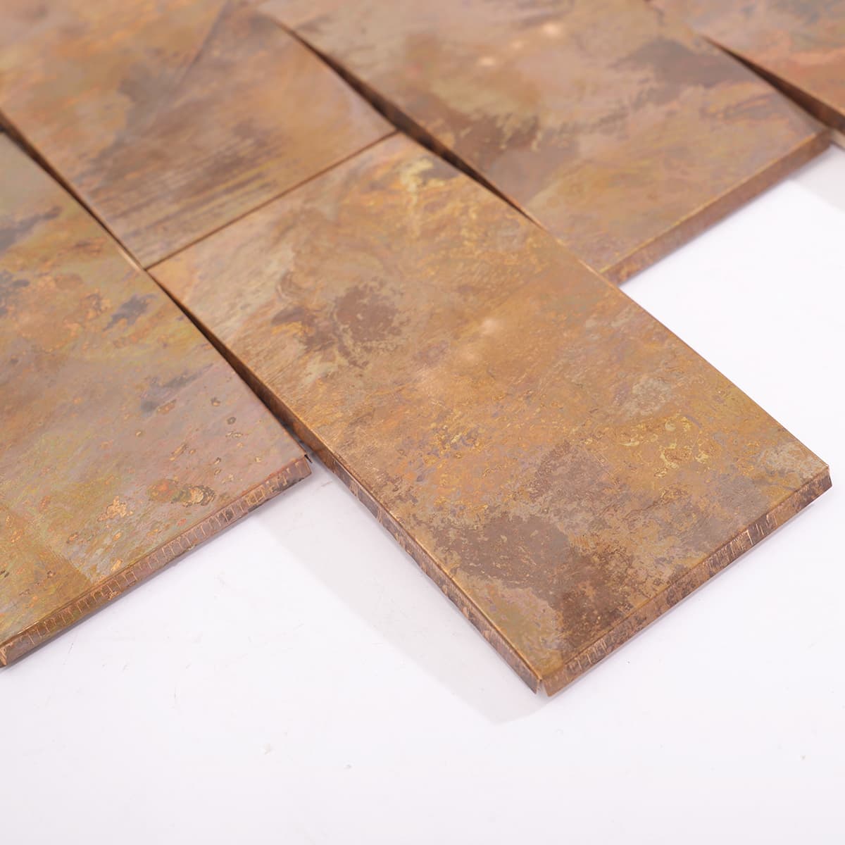 Edge view of curved copper mosaic tile pieces