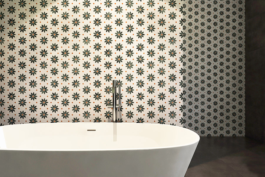 Wide bathroom view with daisy marble mosaic wall tiles and a freestanding tub