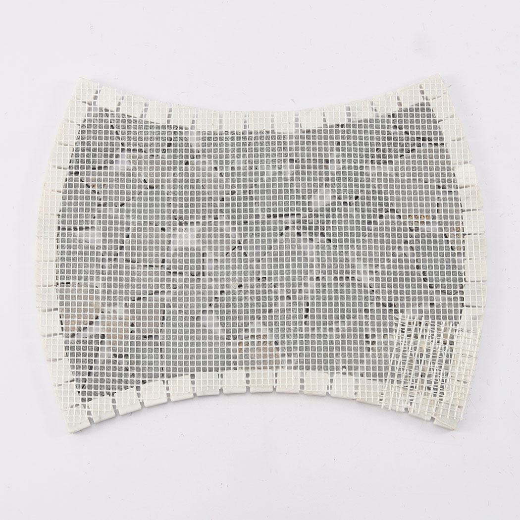 Back view of dark brown broken marble mosaic tile showing white mesh backing