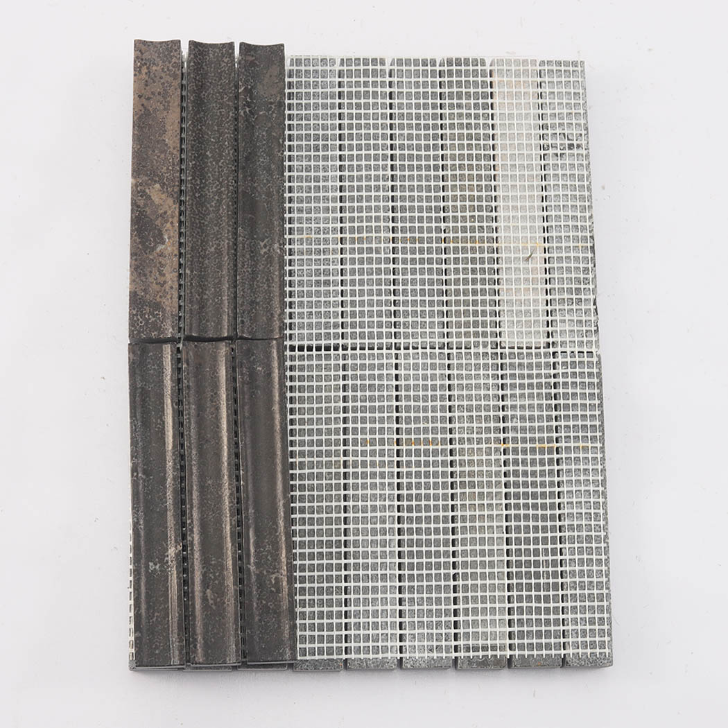 Back view of dark brown fluted marble mosaic tile showing mesh mounted backing