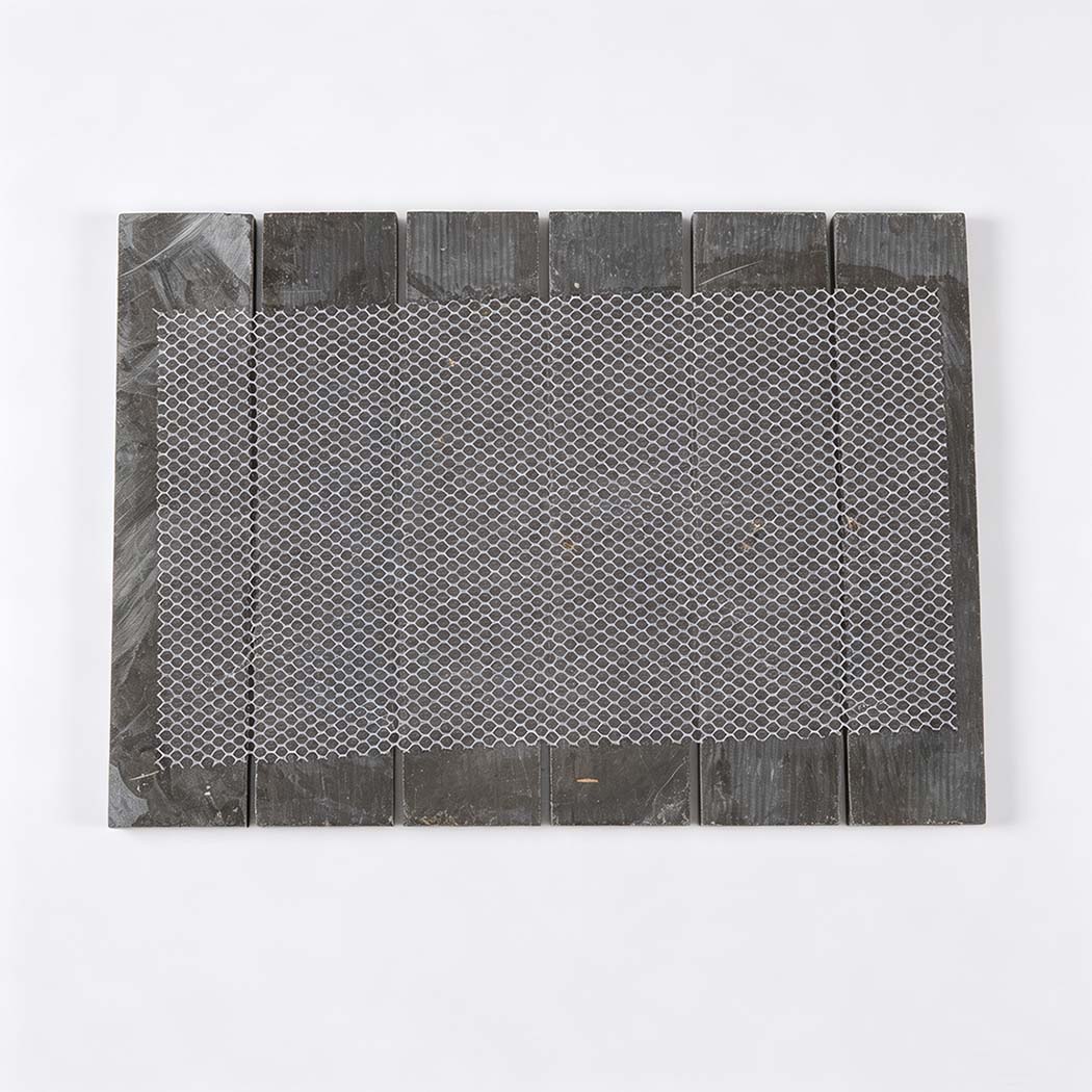 Mesh backing view of a dark brown marble mosaic tile sheet.
