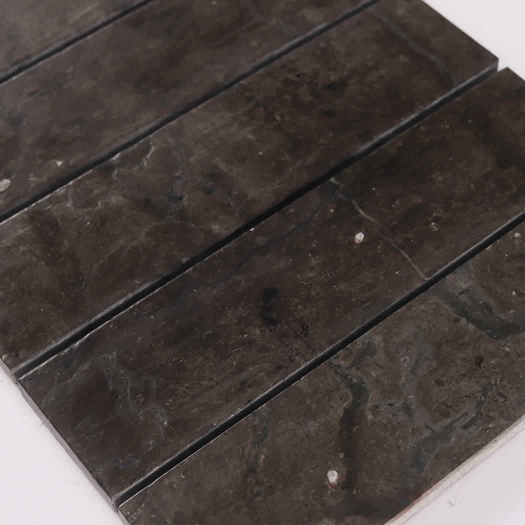 Surface detail of dark brown marble linear stacked tiles.