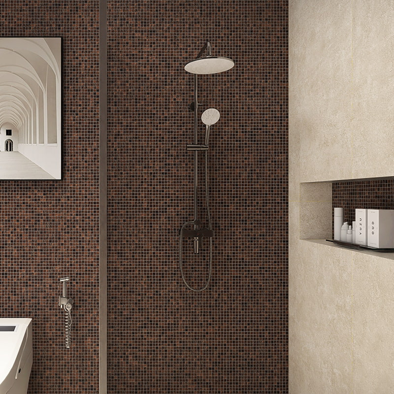 Dark brown mosaic wall tiles behind a sleek shower fixture