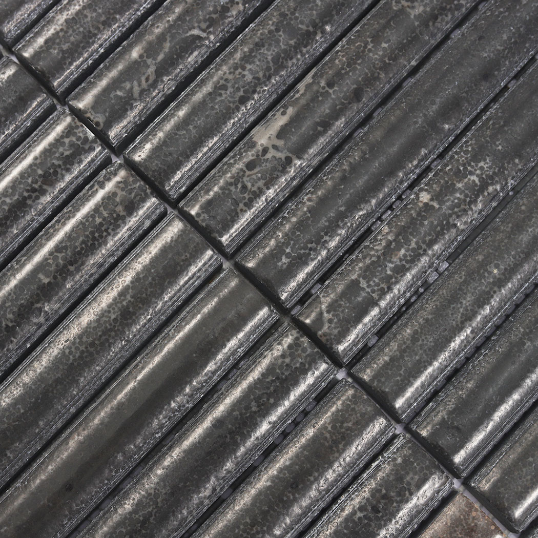 Close-up of dark brown rounded fluted marble mosaic with aged stone texture
