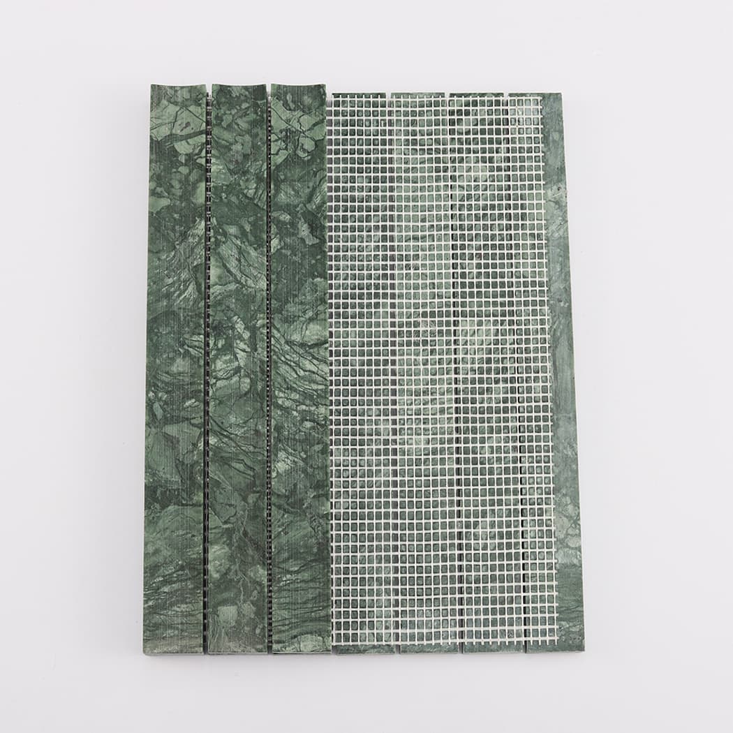 Back view of dark green fluted marble mosaic tile showing white mesh mounting.