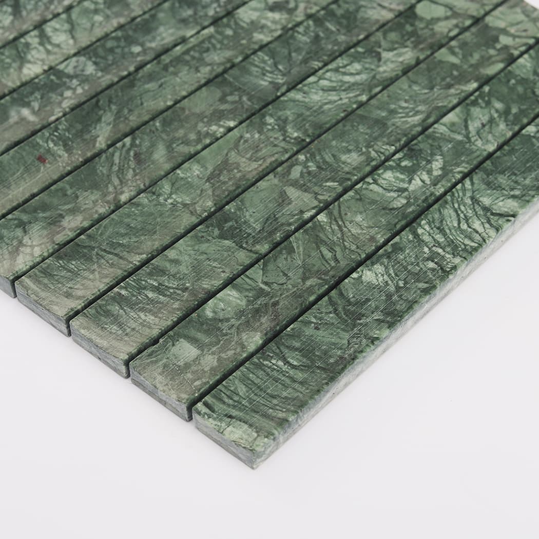 Side angle view highlighting the raised fluted profile of dark green marble tiles.