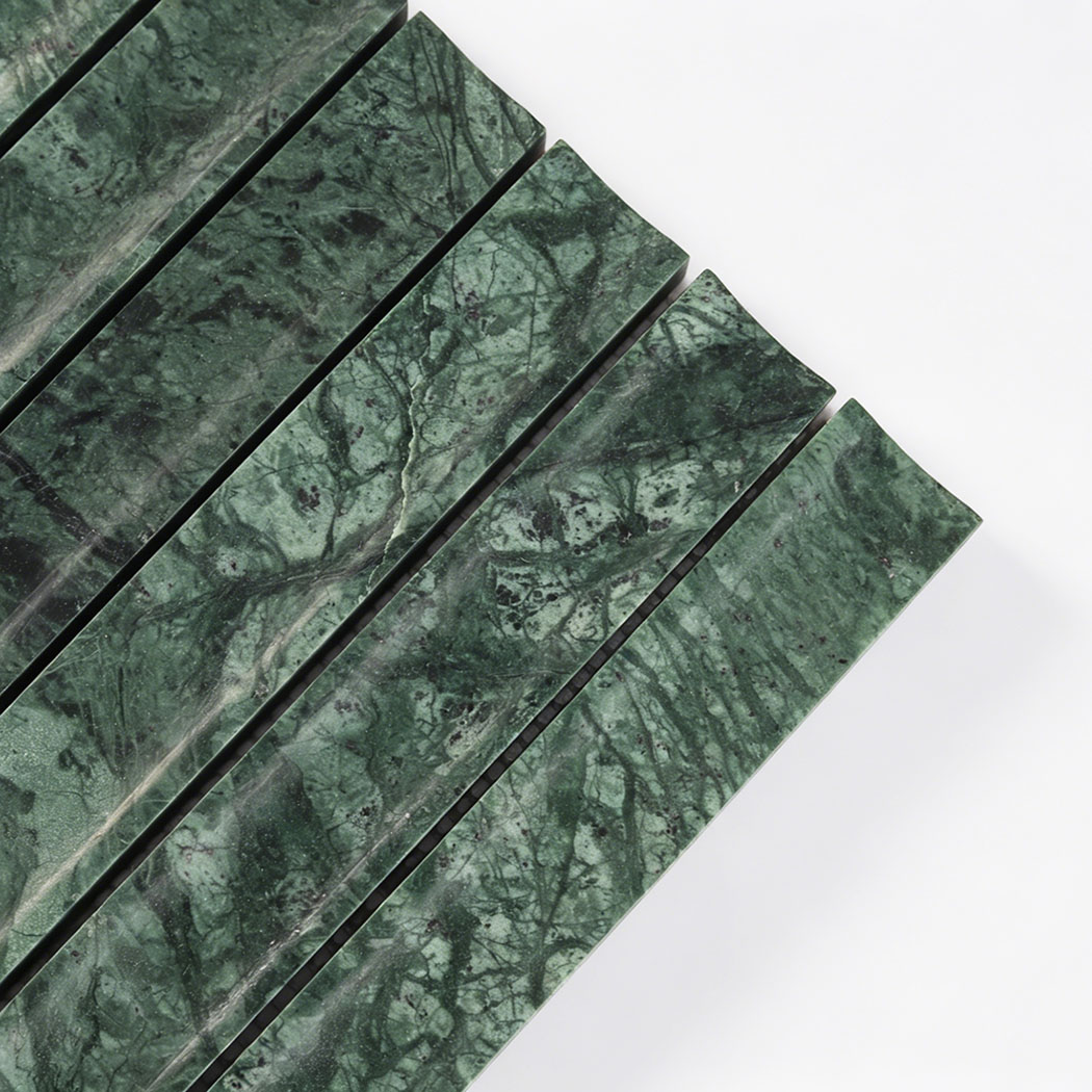 Close-up of dark green marble curved fluted tile strips in diagonal view