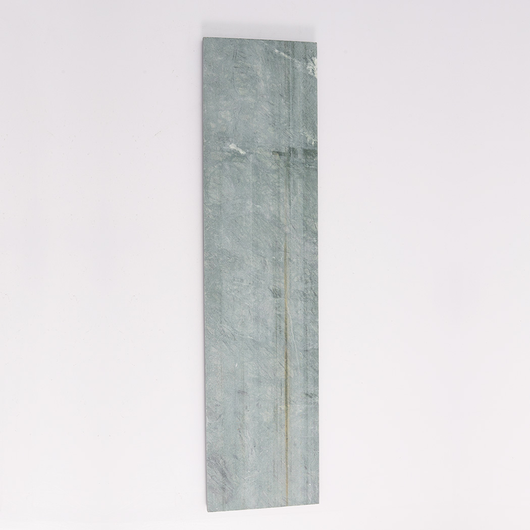 Back view of dark green marble round fluted tile with flat stone surface