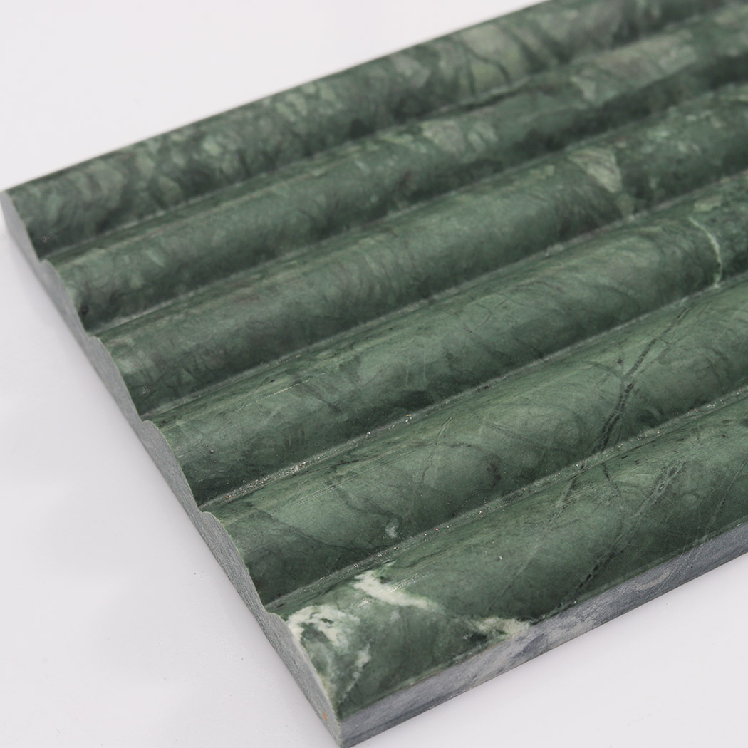 Thickness detail of dark green marble round fluted tile with curved ridges