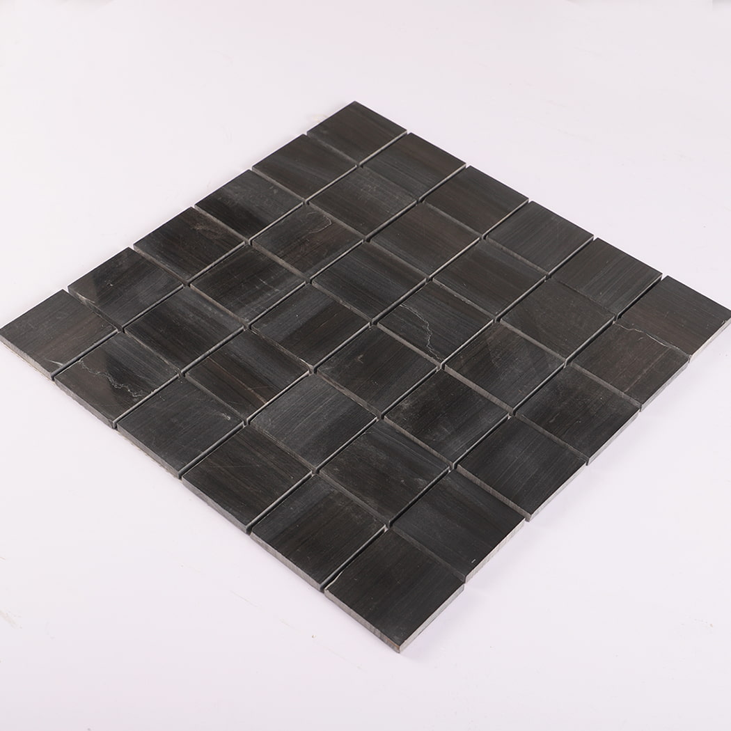 Angled view of dark grey marble square mosaic tile sheet.