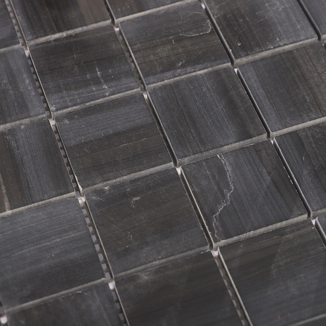 Diagonal close-up showing natural veining of dark grey marble mosaic tile.