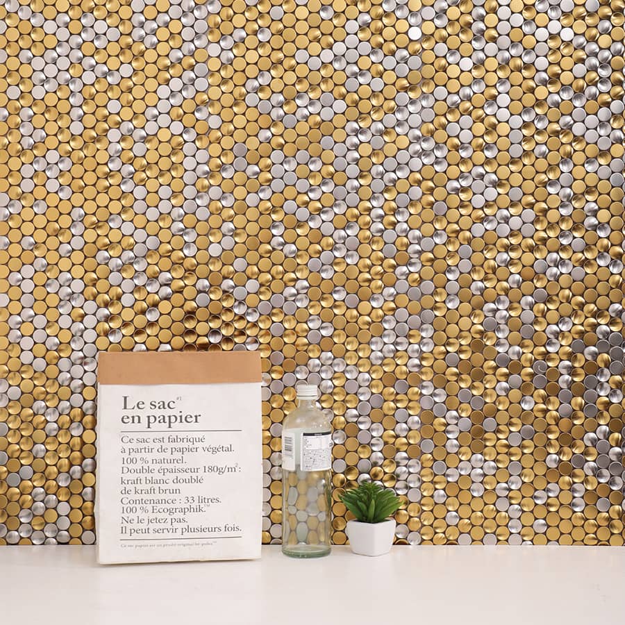 Decorative wall with gold and silver round mosaic tiles and table decor