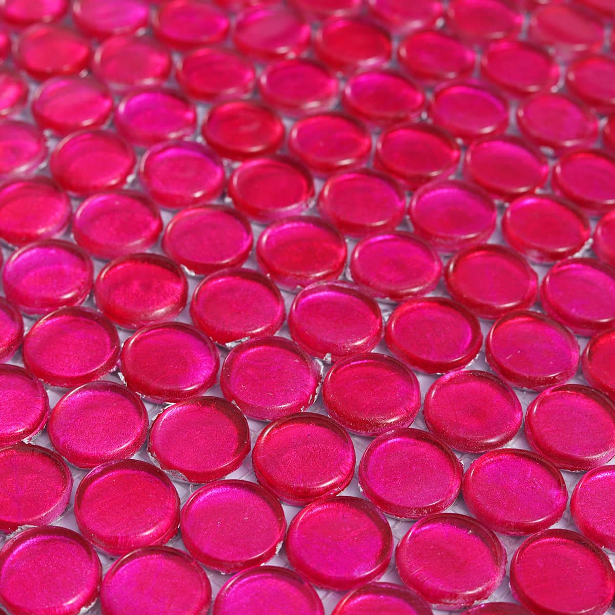 Angled surface view of deep pink round glass mosaic tiles