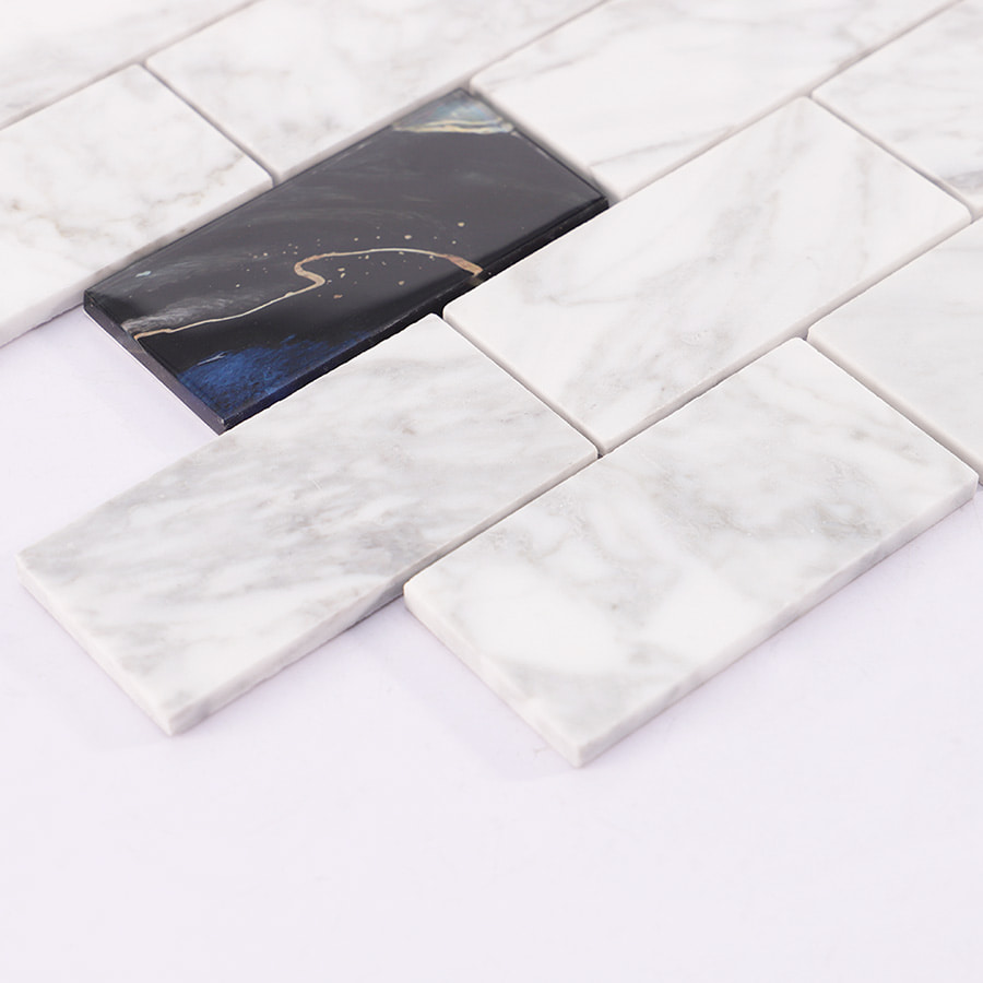 Detailed view of white marble and black glass subway tile with natural patterns