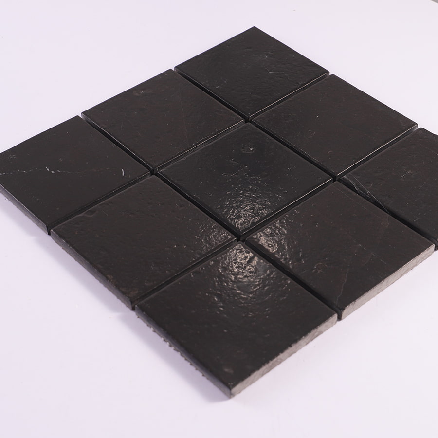 Diagonal angle view of black square stone mosaic tile sheet