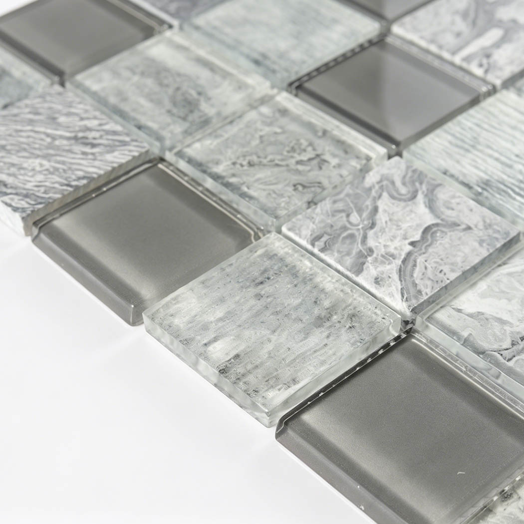 Angled view of raised gray glass square tiles with mixed frosted textures