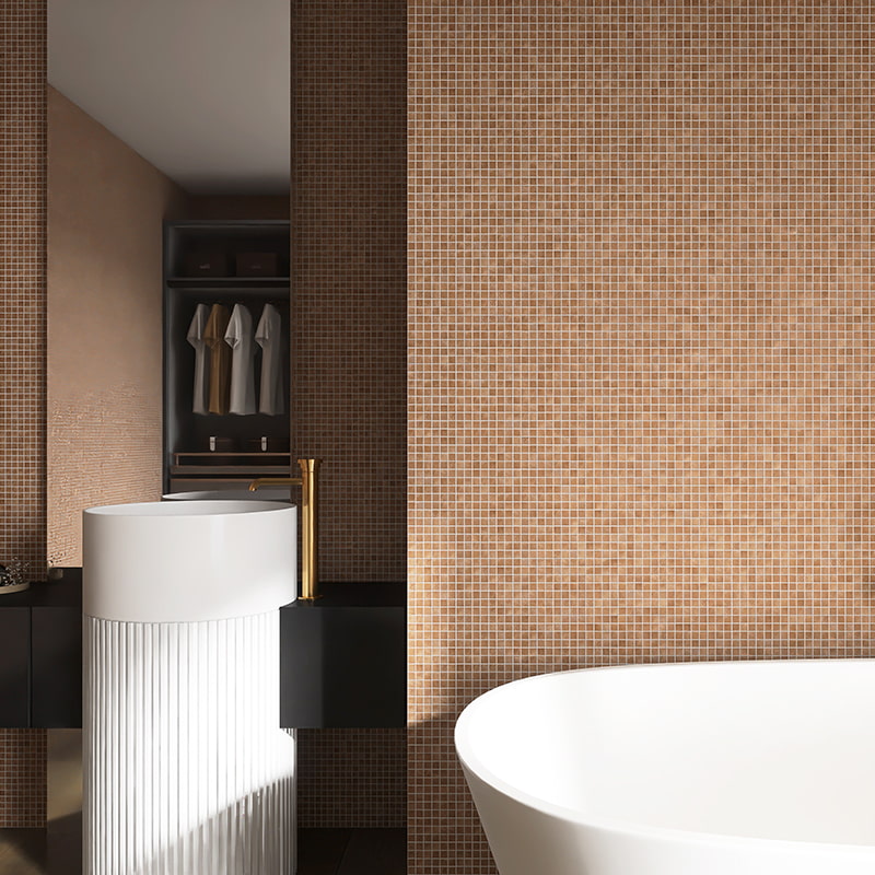 Light brown glass mosaic tile on bathroom wall with warm lighting