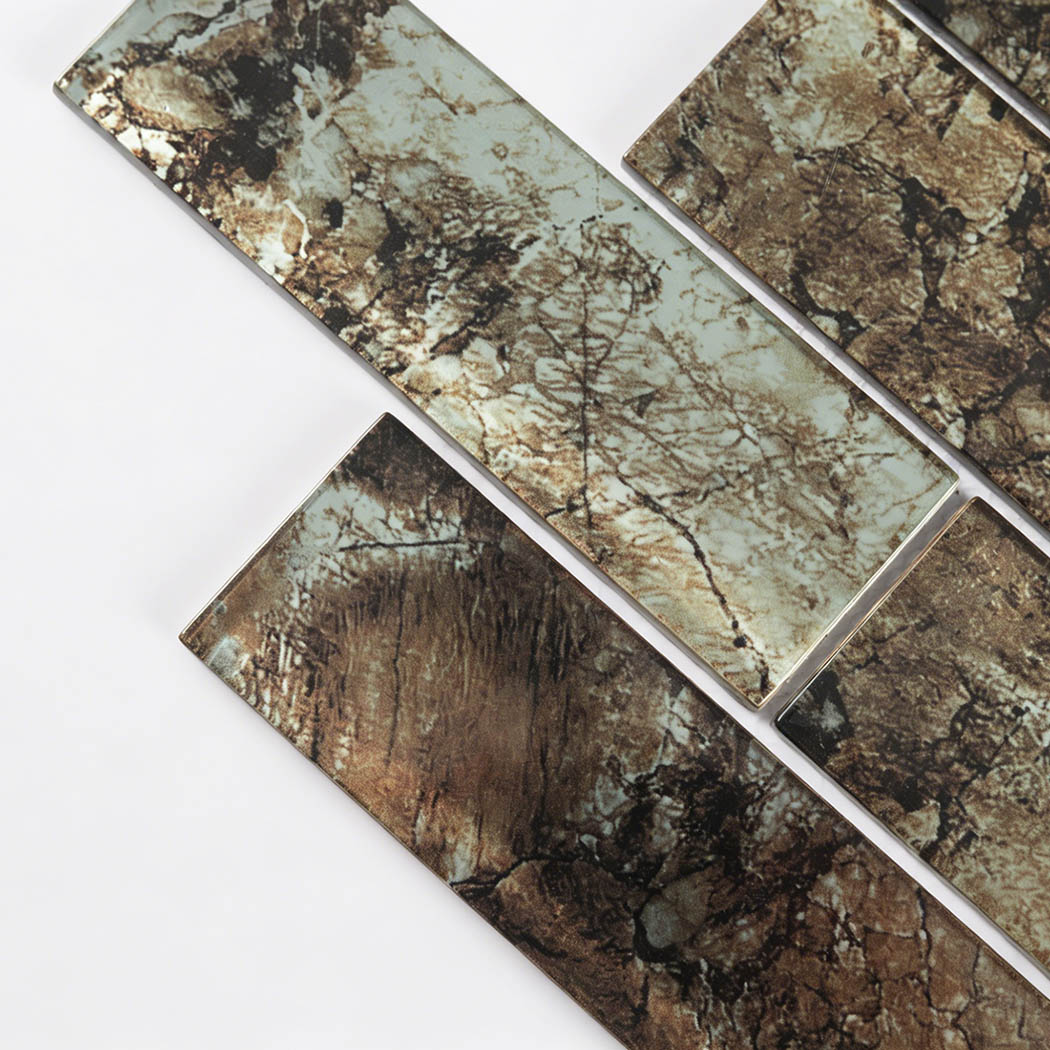 Earth tone glass subway strips showing cracked stone effect and beveled edges