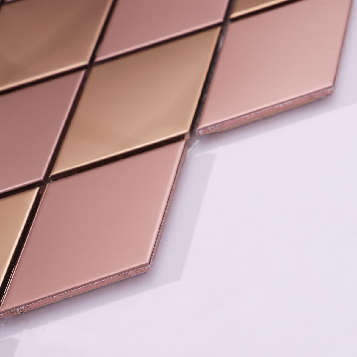 Detail of edge and surface of rose gold diamond mosaic tile