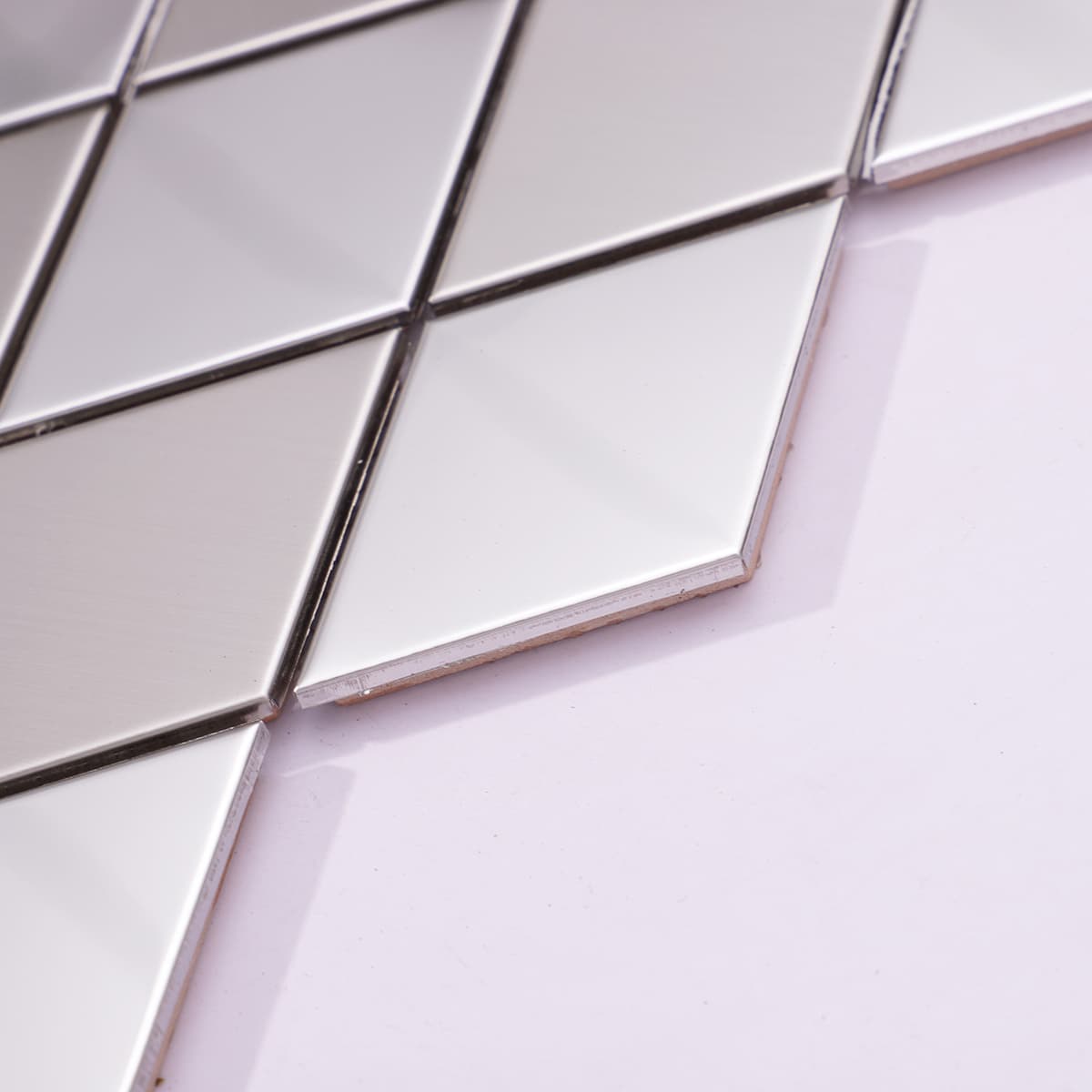 Detail of edge and finish of silver diamond mosaic tile