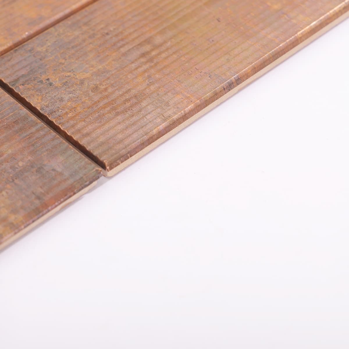 Edge view of vintage copper tile sheet with lined surface