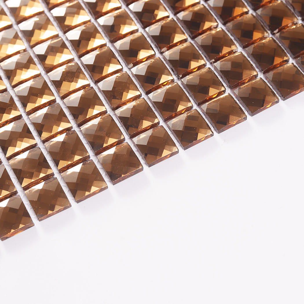 Angled perspective view showing the edge thickness of bronze crystal glass mosaic chips.