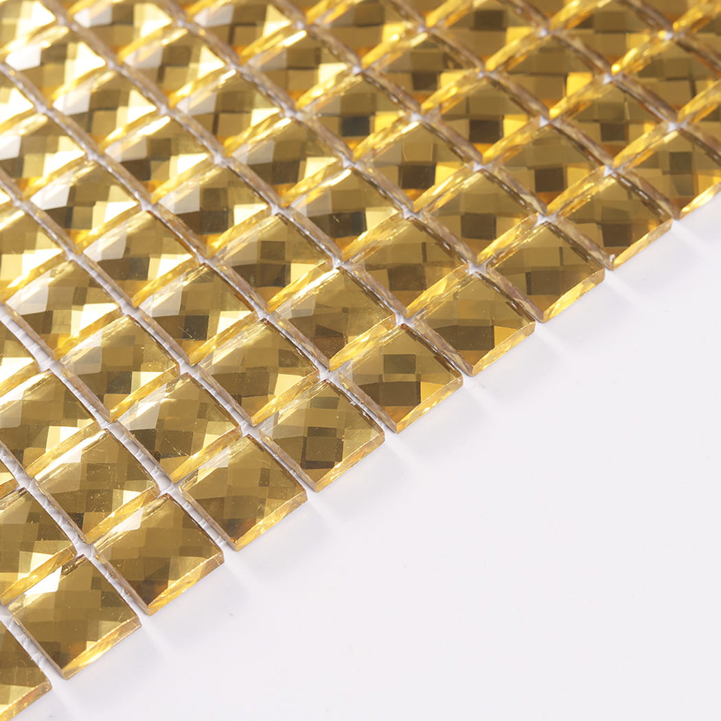 Angled edge view highlighting the thickness of gold square mirror glass mosaic chips.