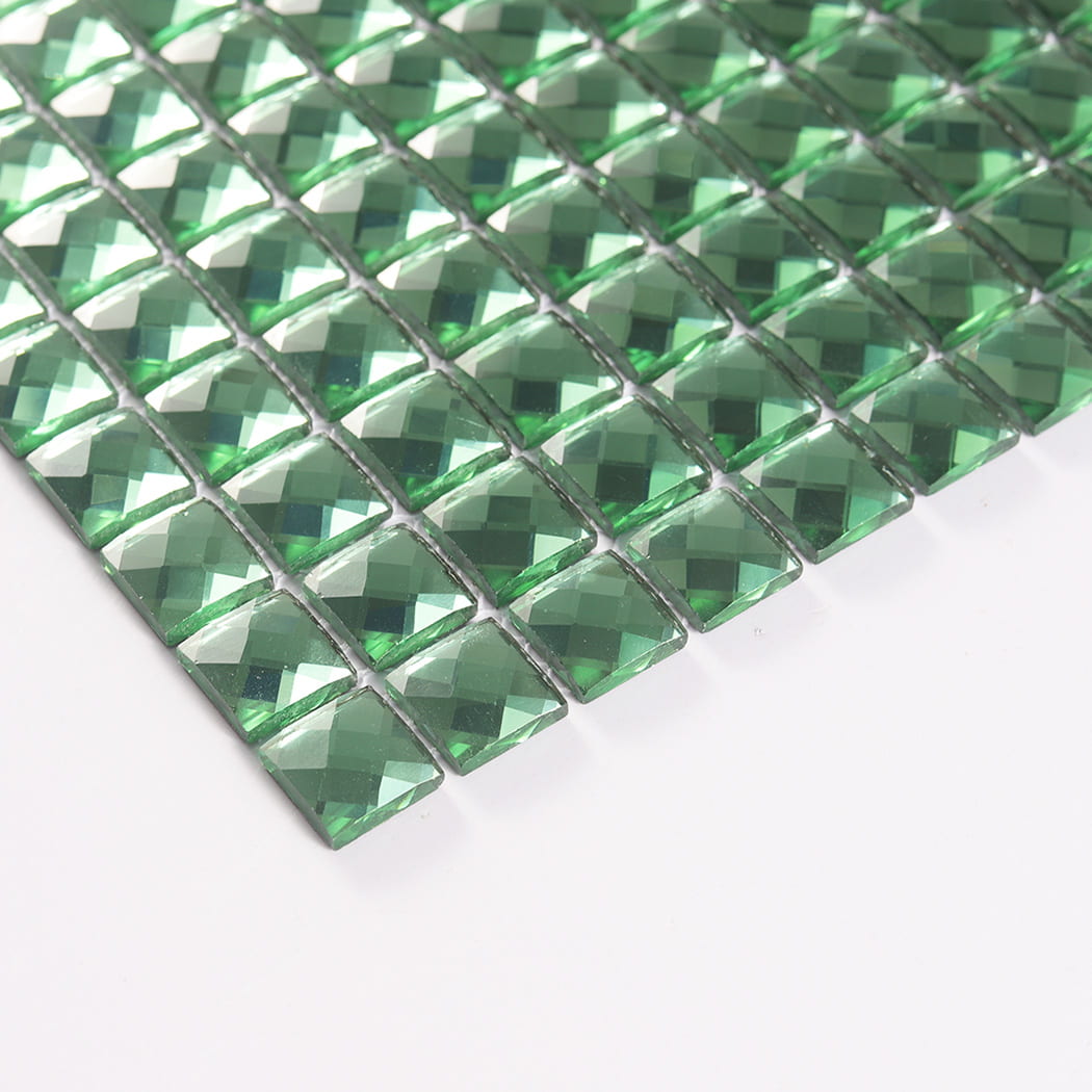 Angled edge view highlighting the thickness of green square mirror glass mosaic chips