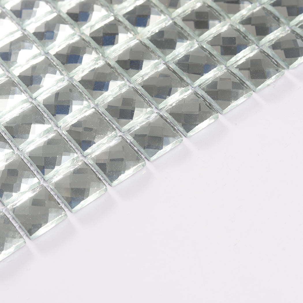 Angled edge view highlighting the thickness of silver square mirror glass mosaic chips.