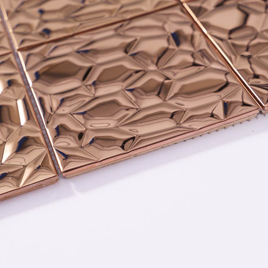Edge view of rose gold stainless steel mosaic tiles with texture