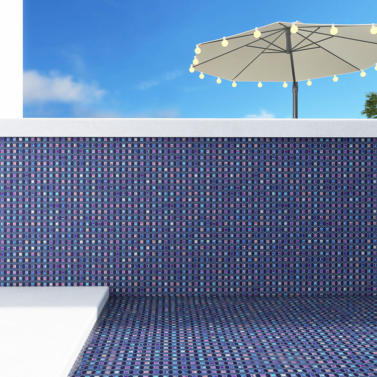 Blue glass mosaic tiles in the swimming pool with a sun umbrella nearby.