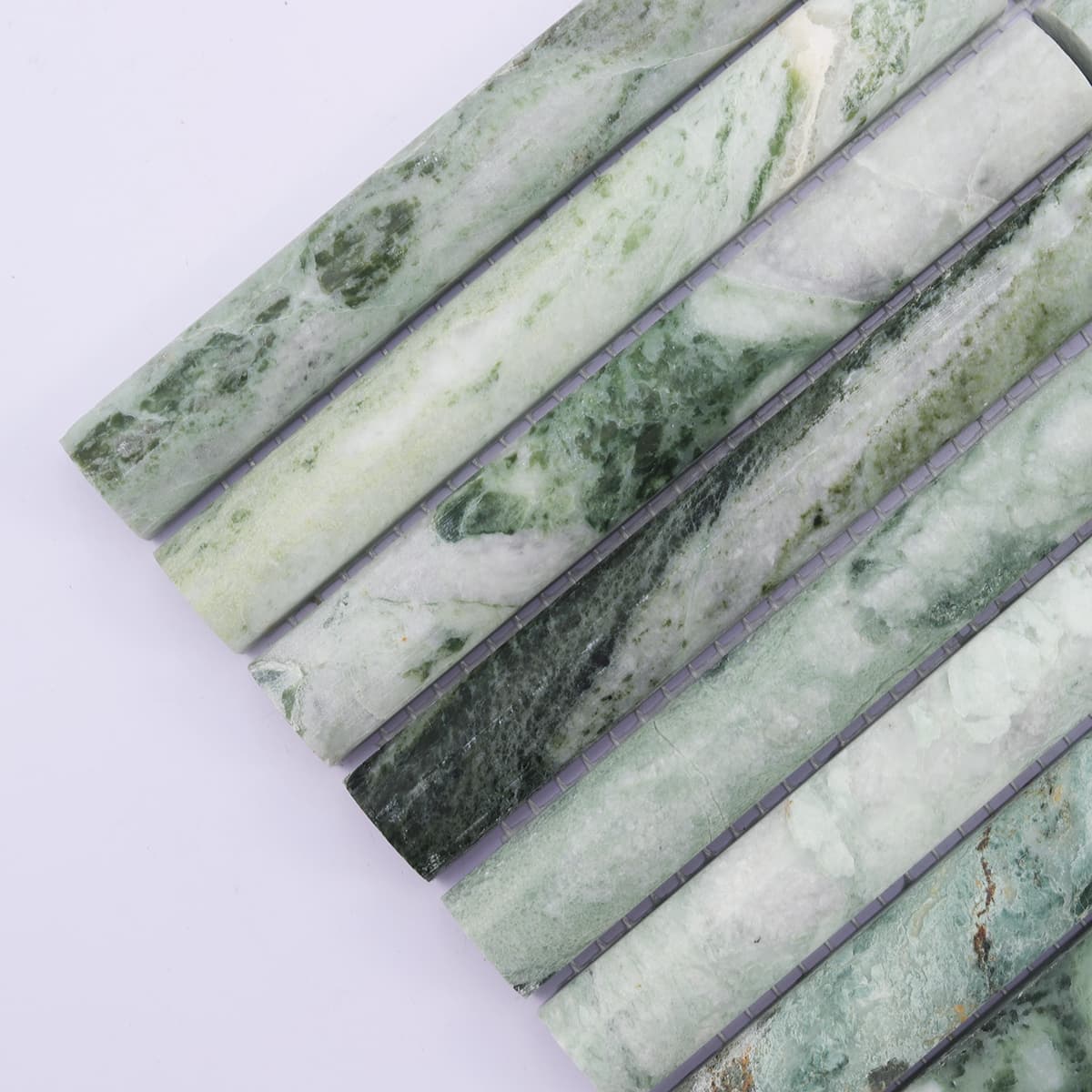 Corner detail of emerald green fluted marble mosaic strips