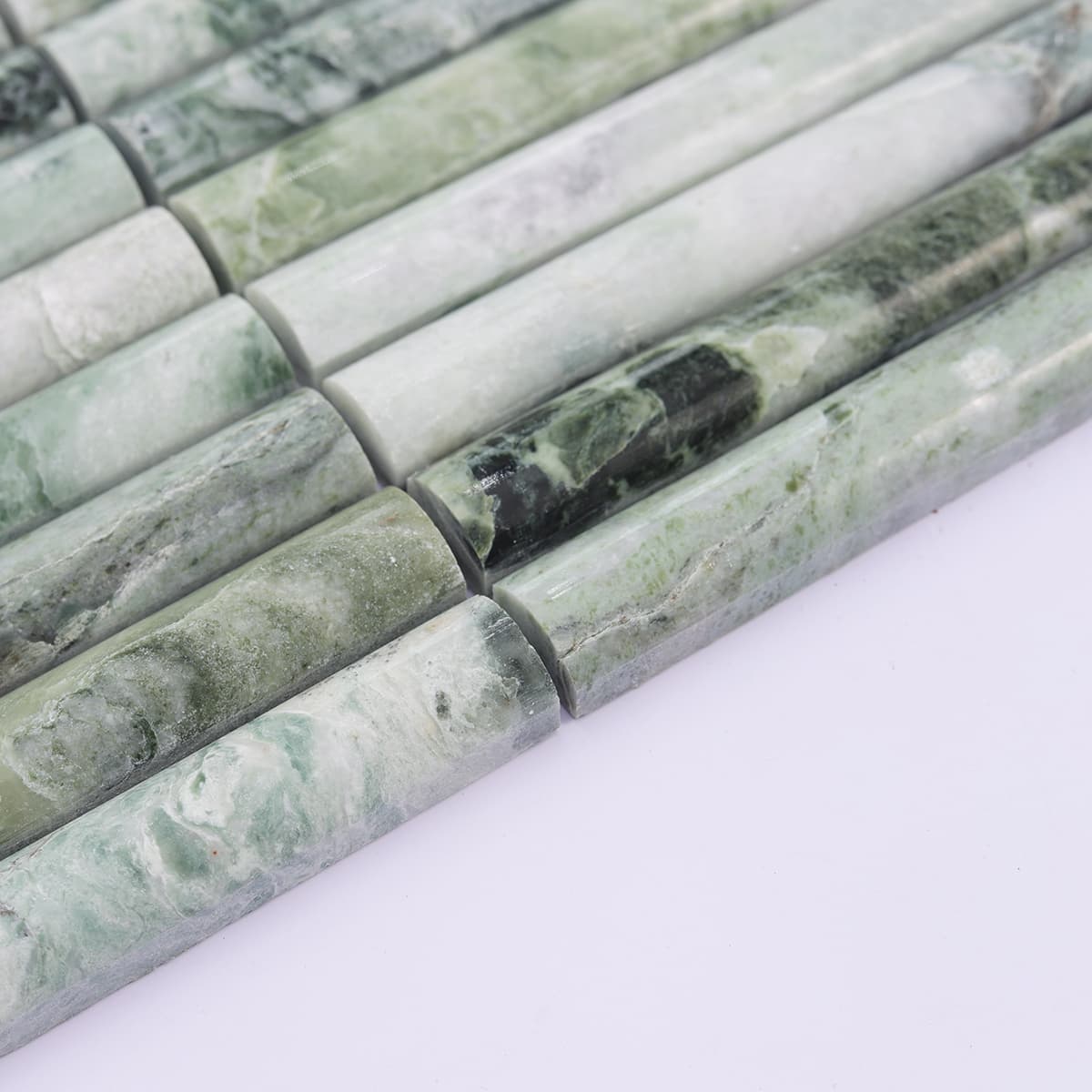 Side angle showing depth of emerald green fluted marble tiles