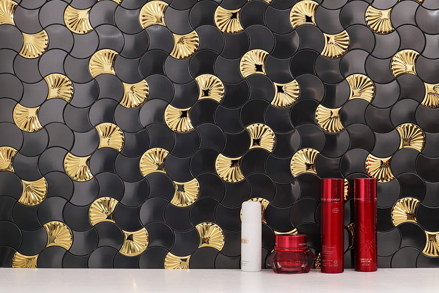 Black and gold fish scale tile backsplash close-up view