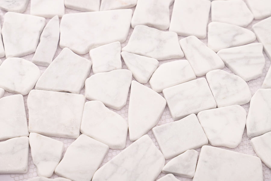 Angled view of flat pebble tile with white broken marble stones, 8mm thickness