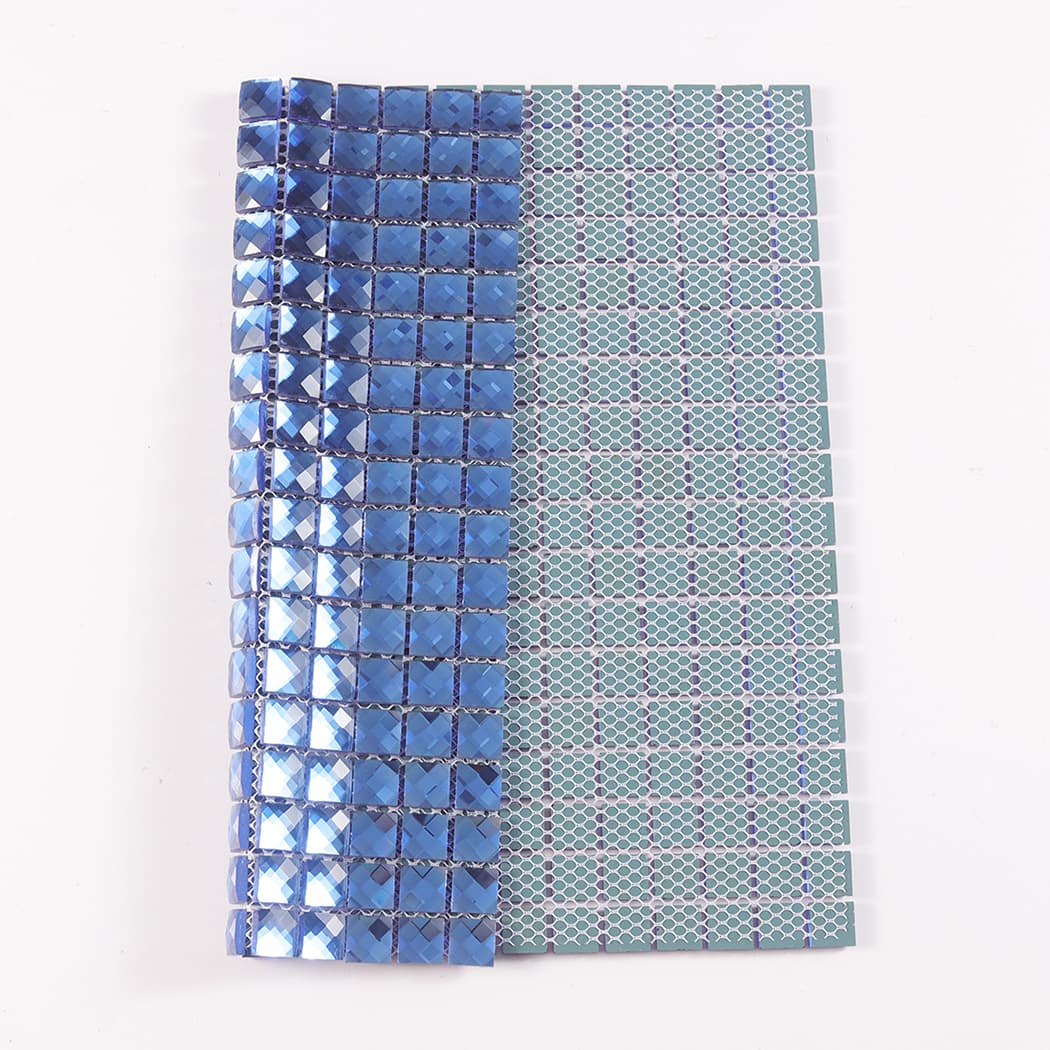Folded blue mirror glass mosaic tile sheet showing its flexible mesh backing on reverse.