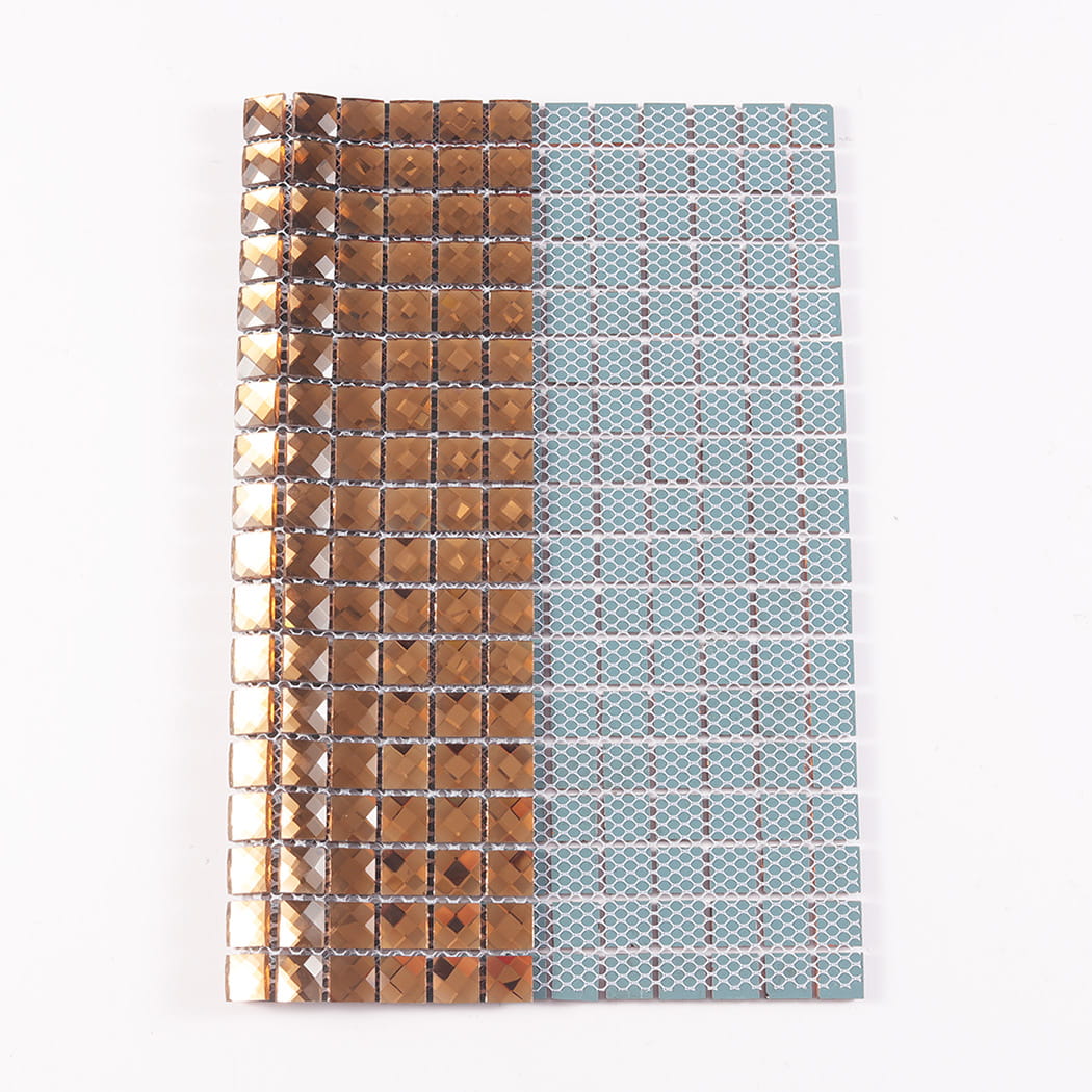 Folded sheet of bronze crystal mirror glass mosaic tiles revealing its flexible mesh backing.