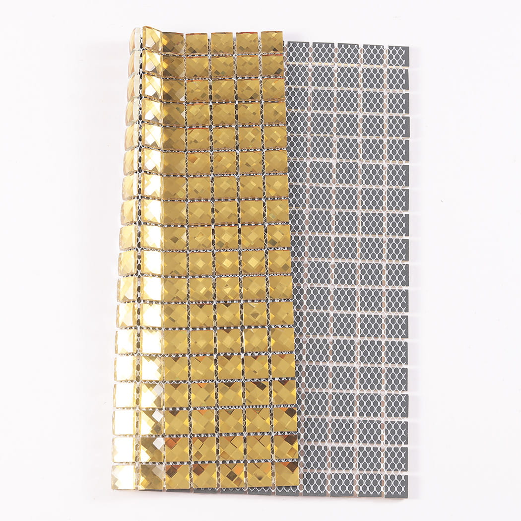 Folded gold mirror glass mosaic tile sheet showing its flexible mesh backing on reverse.