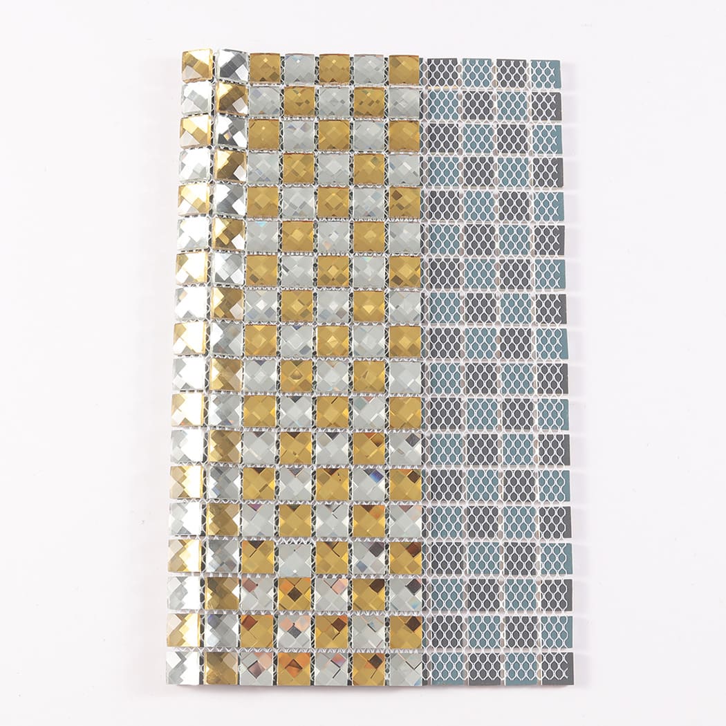Folded gold and silver glass mosaic tile sheet showing its flexible mesh backing.