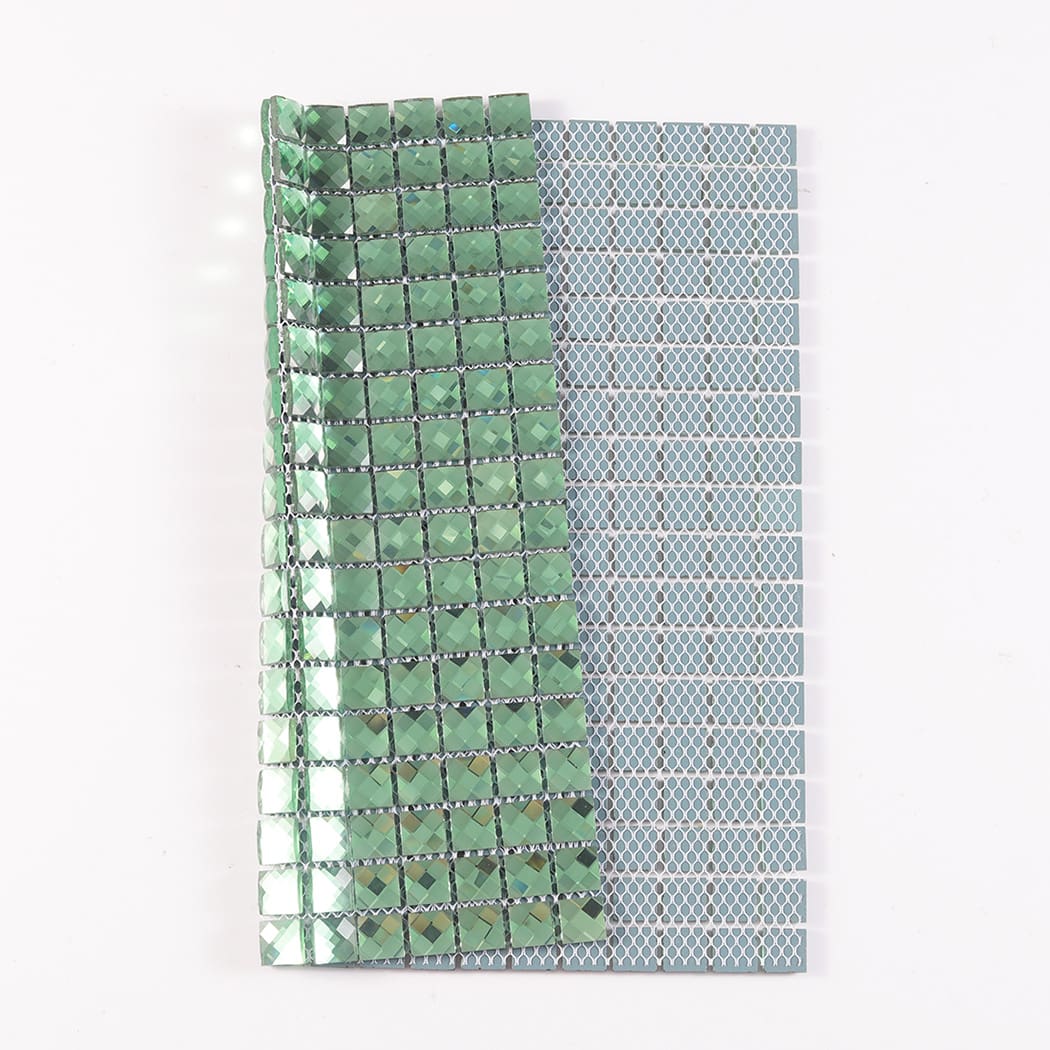 Folded green mirror glass mosaic tile sheet showing its flexible mesh backing on reverse.